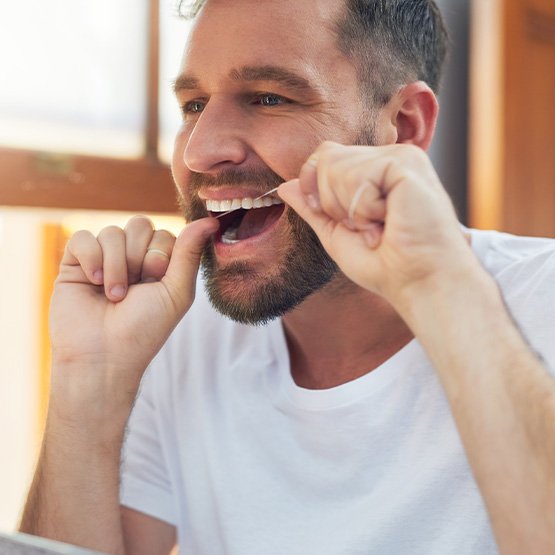 Man flossing his teeth